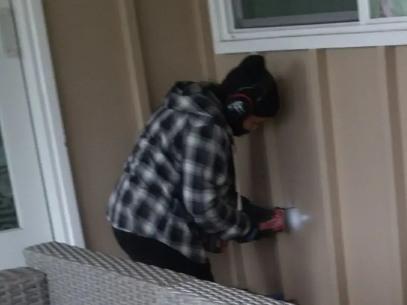 Professional electrician installing an exterior outlet in Thomaston